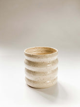 Load image into Gallery viewer, Wheel thrown planter with 4 defined bumps in a cream and brown speckled clay