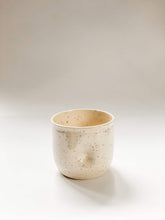 Load image into Gallery viewer, Wheel thrown planter with indent in middle like a belly button in a cream and brown speckled clay