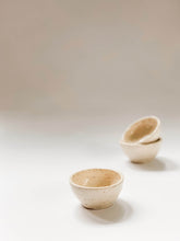 Load image into Gallery viewer, One small cream and speckled bowl in the foreground, two stacked small bowls in the background