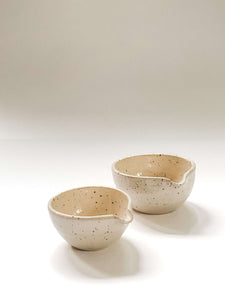 Two small wheel thrown bowl with a pouring spout in cream clay with speckles