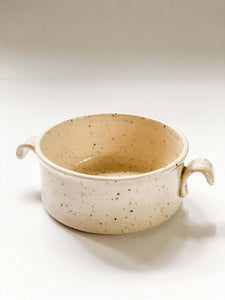 Birds eye view of wheel thrown cylindrical soup bowls with two hooked handles in a cream and brown speckled clay
