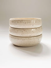 Load image into Gallery viewer, 3 stacked low profile bowls wheel thrown in a cream and brown speckled clay