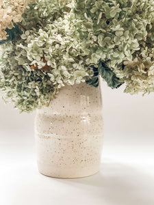 Tall, two sectioned wheel thrown vase in cream and brown speckled clay with hydrangeas 