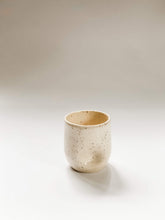 Load image into Gallery viewer, A wheel thrown tumbler in cream clay with speckles with two dimples pinched into the sides