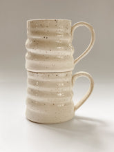 Load image into Gallery viewer, Two stacked wheel thrown mug with pronounced spiral throwing marks in cream and brown speckled clay  