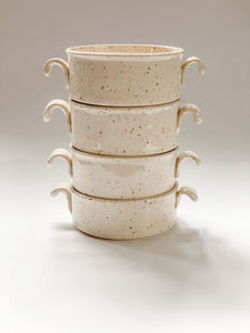 4 stacked wheel thrown cylindrical soup bowls with two hooked handles in a cream and brown speckled clay