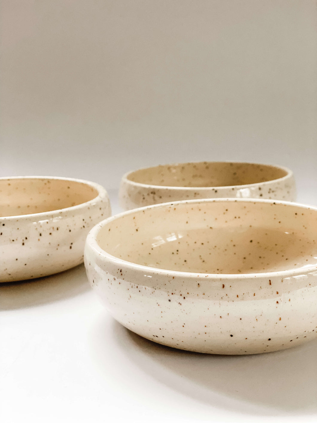 Low profile bowls wheel thrown in a cream and brown speckled clay