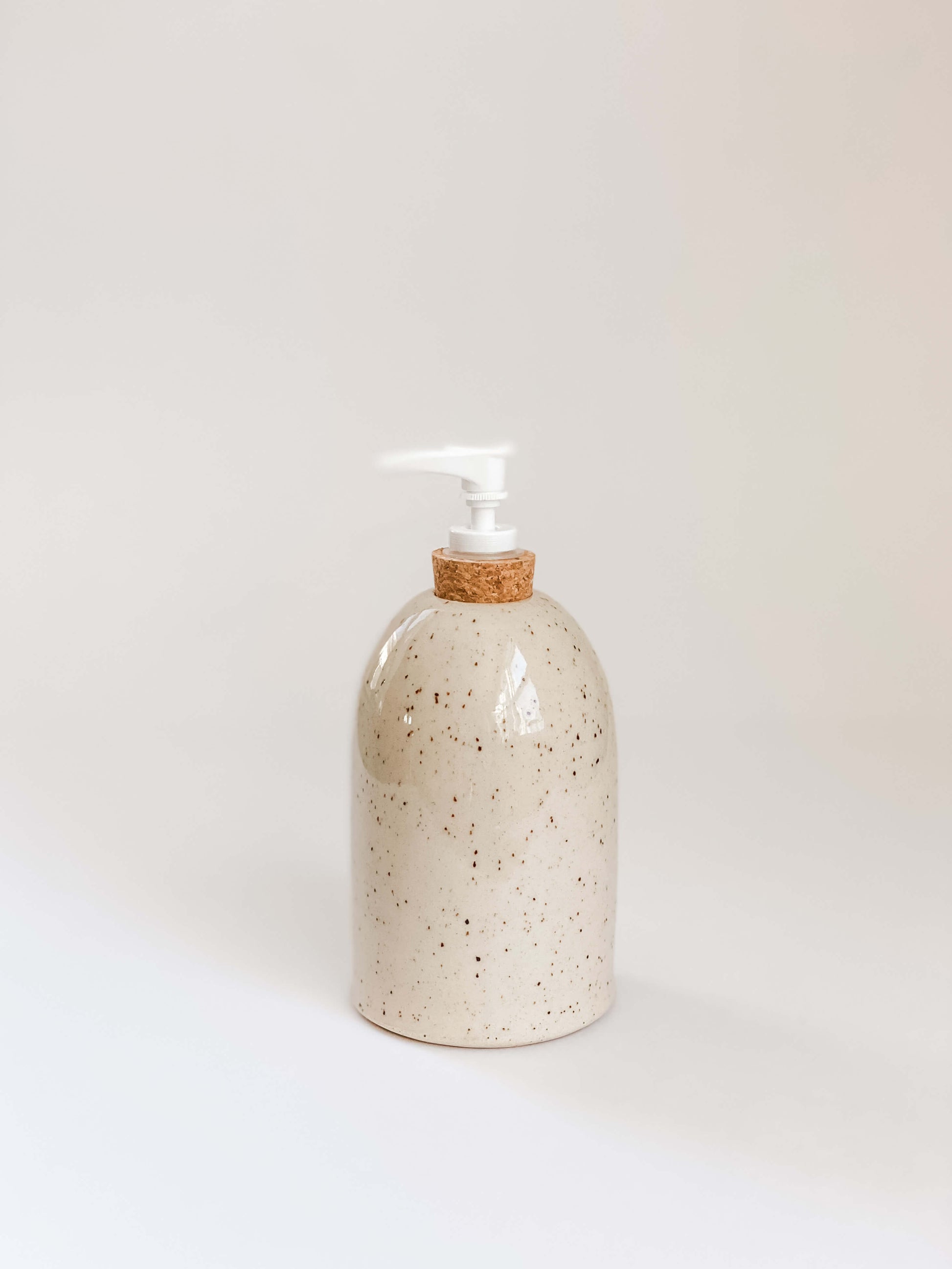 Single speckled stoneware pottery soap pump with cork sleeve and white pump