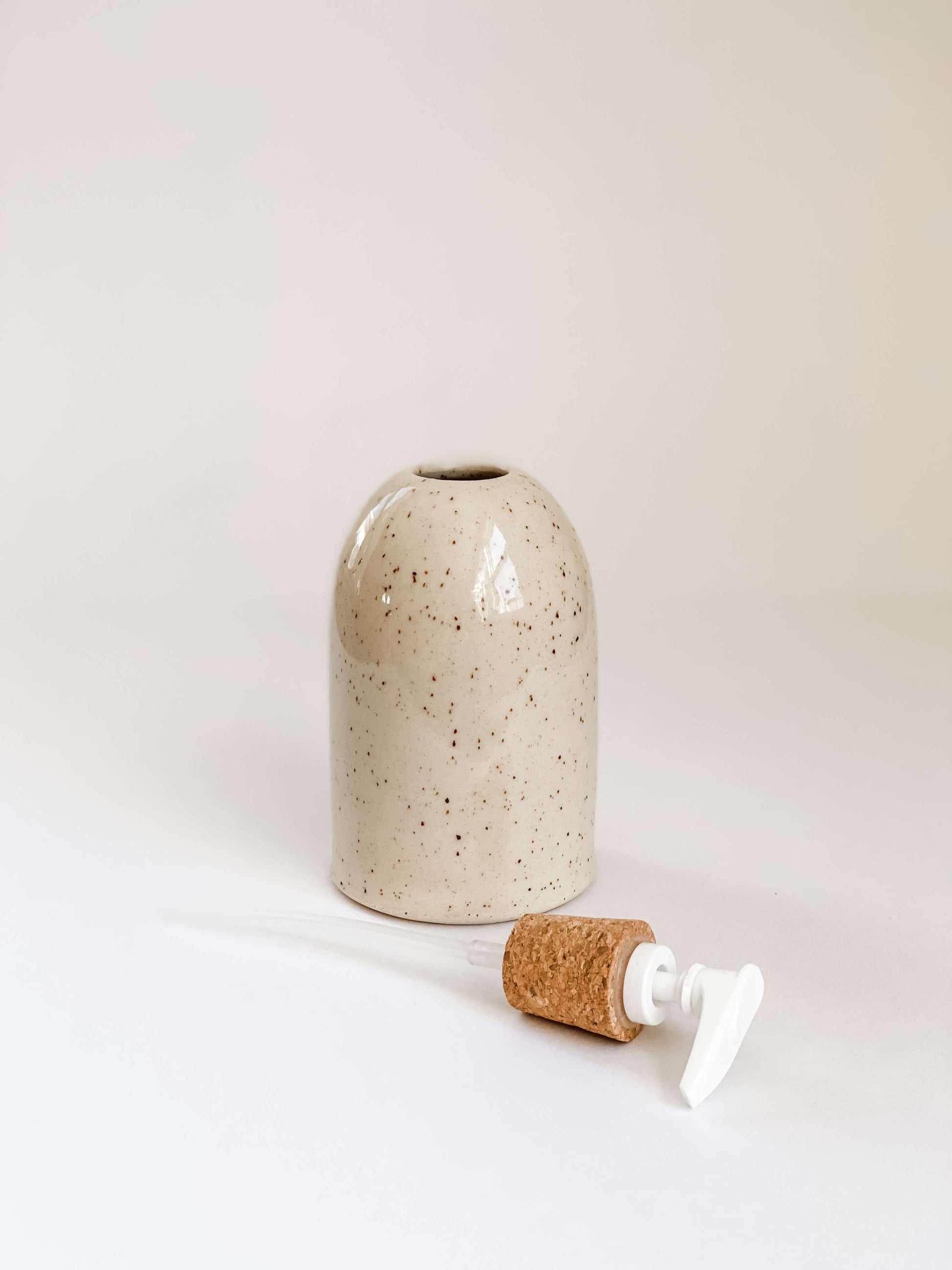 Speckled stoneware pottery soap pump with cork sleeve and pump removed