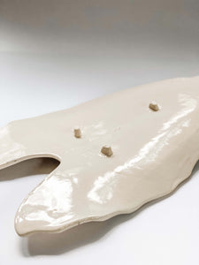 Underside of leaf platter in white porcelain clay showing 3 feet 