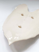 Load image into Gallery viewer, Underside of leaf platter in white porcelain clay showing 3 feet 