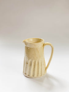 Wheel thrown, hand carved yellow speckled pitcher 