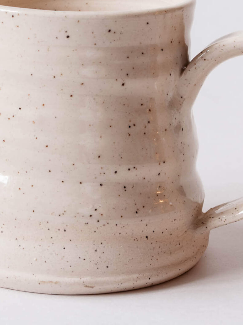 Close up of mug to show the glossy top the raw clay bottom